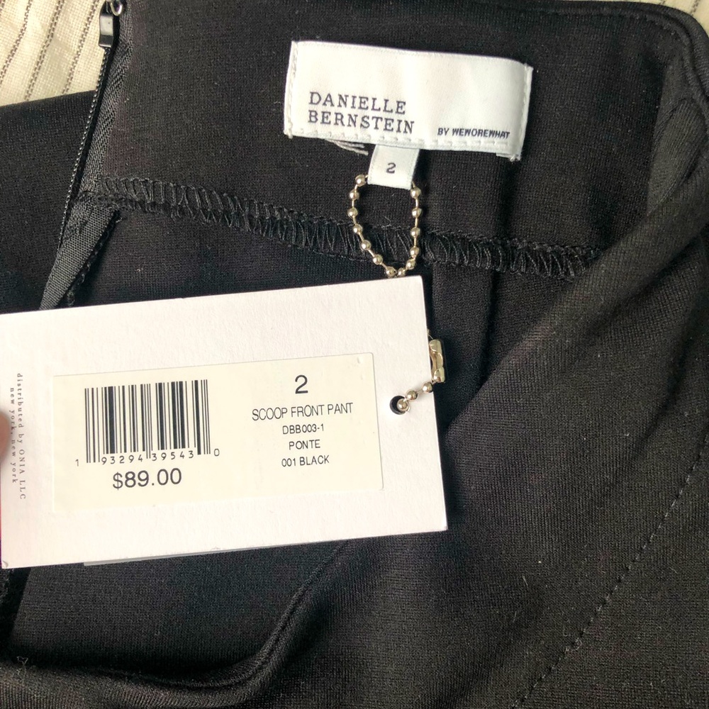 NWT. Danielle Bernstein by WeWoreWhat black scoop front flared pant. Size 2